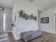 An entryway with a gray cushioned bench, and charming decor offers a cozy welcome at 48 Lark Dr, Placida, FL 33946