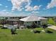 Lovely home boasts a screened pool, pristine lawn, and mature landscaping under a sunny sky at 48 Lark Dr, Placida, FL 33946
