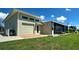 Exterior of home showing back lawn, screened in porch and attached garage at 48 Lark Dr, Placida, FL 33946
