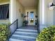 Entrance to a home with tiled front porch, glass front door, and stylishly decorated with potted plants at 48 Lark Dr, Placida, FL 33946