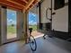 Garage interior with bicycle and door leading to outdoor scenery at 48 Lark Dr, Placida, FL 33946