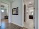 A hallway showcasing wood and tile floors leads to a bedroom and bathroom at 48 Lark Dr, Placida, FL 33946