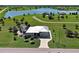 An aerial view shows a beautiful home with a metal roof and a screened-in pool surrounded by green grass at 48 Lark Dr, Placida, FL 33946