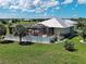 A detailed aerial view shows a large enclosed porch and outdoor sitting area in the backyard of a home at 48 Lark Dr, Placida, FL 33946