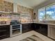 Charming kitchen with stainless steel appliances, granite countertops, and a brick accent wall at 48 Lark Dr, Placida, FL 33946