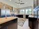 Modern kitchen featuring brick accent wall, stainless steel appliances, and plenty of counter space at 48 Lark Dr, Placida, FL 33946