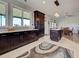 Open kitchen with large windows, an island, granite counters, and dark wood cabinetry at 48 Lark Dr, Placida, FL 33946