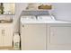 Bright laundry room features washer, dryer, sink and storage, adding functionality to the home at 48 Lark Dr, Placida, FL 33946