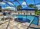 Lush backyard view showcasing a beautiful screened-in pool with outdoor seating at 48 Lark Dr, Placida, FL 33946