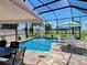 Outdoor pool with patio, pool furniture, screen enclosure, and tropical landscaping at 48 Lark Dr, Placida, FL 33946