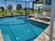 Beautiful screened-in pool with crystal-clear water and serene backyard views at 48 Lark Dr, Placida, FL 33946