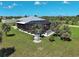 Aerial view of a home featuring a screen enclosed pool, beautiful yard and tropical foliage at 48 Lark Dr, Placida, FL 33946