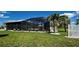 Screened in pool with patio furniture and lush green landscaping at 48 Lark Dr, Placida, FL 33946