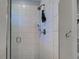Close-up of a modern shower with sleek white tiles and a convenient hand-held shower head at 48 Lark Dr, Placida, FL 33946
