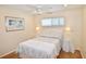 Charming bedroom with a ceiling fan, wood-look floors, and relaxing decor at 528 Barcelona Ave # 216, Venice, FL 34285