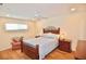 Cozy bedroom featuring a ceiling fan, wood-look floors, and a comfortable bed at 528 Barcelona Ave # 216, Venice, FL 34285
