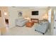 Comfortable living room with neutral tones, tile flooring, and ample natural light at 528 Barcelona Ave # 216, Venice, FL 34285