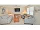 Cozy living room with comfortable seating and a mounted television at 528 Barcelona Ave # 216, Venice, FL 34285