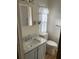 Bathroom featuring a sink, mirror and vanity plus wood look floors at 529 Cervina S Dr, Venice, FL 34285