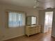 Bedroom featuring two windows, a ceiling fan, wood-look floors and a dresser at 529 Cervina S Dr, Venice, FL 34285