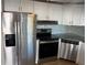 Bright kitchen with stainless steel appliances, including a refrigerator, range, and dishwasher, perfect for cooking at 529 Cervina S Dr, Venice, FL 34285