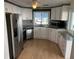 Modern kitchen featuring stainless steel appliances, white cabinets, granite countertops, and stylish backsplash at 529 Cervina S Dr, Venice, FL 34285