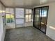 Bright sunroom with multiple windows and sliding glass door at 529 Cervina S Dr, Venice, FL 34285