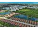 Panoramic aerial shot showcases the community's layout, featuring homes, lakes, and lush landscaping near the ocean at 5832 Semolino St, Nokomis, FL 34275