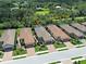Aerial view of a neighborhood featuring well-maintained homes with tile roofs and a green space called Legacy Trail at 5832 Semolino St, Nokomis, FL 34275