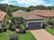 Beautiful aerial view of a single-story home with tile roof, lush landscaping, and a paver driveway at 5832 Semolino St, Nokomis, FL 34275