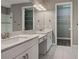Stylish bathroom with double sinks, marble countertops, tile floors, and walk-in closet at 5832 Semolino St, Nokomis, FL 34275