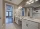 Elegant bathroom featuring double sinks with marble countertops and views to the main bedroom at 5832 Semolino St, Nokomis, FL 34275