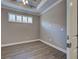 Bright bedroom with hardwood floors, neutral walls, and natural light at 5832 Semolino St, Nokomis, FL 34275