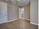 Bedroom features light wood-look floors and white baseboards with a doorway leading to another room at 5832 Semolino St, Nokomis, FL 34275