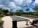 Bocce ball court with lush landscaping, and seating area offers an inviting outdoor recreational space for residents to enjoy at 5832 Semolino St, Nokomis, FL 34275