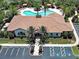 An aerial view features a clubhouse with a pool, meticulously landscaped grounds, and ample parking at 5832 Semolino St, Nokomis, FL 34275