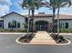 Elegant clubhouse featuring a brick walkway and lush landscaping at 5832 Semolino St, Nokomis, FL 34275