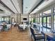Spacious dining room with elegant tables, chairs and large windows providing abundant natural light at 5832 Semolino St, Nokomis, FL 34275