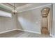 Empty dining room featuring wood floors, an elegant hanging light fixture, and trim that matches the ceiling and doorframe at 5832 Semolino St, Nokomis, FL 34275