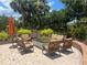 An outdoor fire pit surrounded by comfortable seating creates an inviting space for relaxation and entertaining guests at 5832 Semolino St, Nokomis, FL 34275