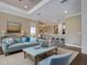 Open-concept living room with wood flooring and large windows with an eat in kitchen at 5832 Semolino St, Nokomis, FL 34275