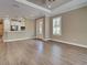 Hardwood floors highlight this living room with a view of the eat-in kitchen at 5832 Semolino St, Nokomis, FL 34275