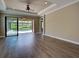 Living room with hardwood flooring with a view of the lanai and backyard pool at 5832 Semolino St, Nokomis, FL 34275