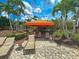 Relaxing outdoor lounge area with shade, featuring cushioned seating, perfect for enjoying the tropical surroundings at 5832 Semolino St, Nokomis, FL 34275