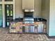 Well-equipped outdoor kitchen boasts a built-in grill, granite countertops, and stainless-steel appliances, perfect for al fresco dining at 5832 Semolino St, Nokomis, FL 34275
