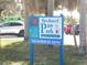 Brohard Paw Park sign with clear address in a sunny, outdoor setting, kayak visible at 5832 Semolino St, Nokomis, FL 34275