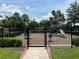 Fenced playground offers children a secure area for outdoor fun, with a variety of play structures and soft ground cover at 5832 Semolino St, Nokomis, FL 34275