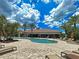 Exterior shot of the community pool and recreation center, surrounded by lush landscaping and inviting lounge areas at 5832 Semolino St, Nokomis, FL 34275