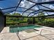 Beautiful pool with screened in lanai and lush landscaping at 5832 Semolino St, Nokomis, FL 34275