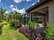 Screened lanai overlooking a pool with tropical landscaping provides a serene backyard oasis at 5832 Semolino St, Nokomis, FL 34275